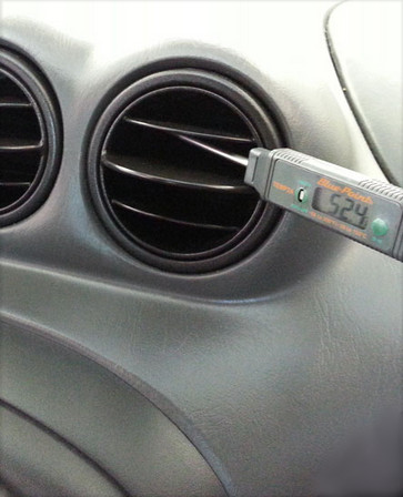 image of auto dash with thermometer testing ac temp